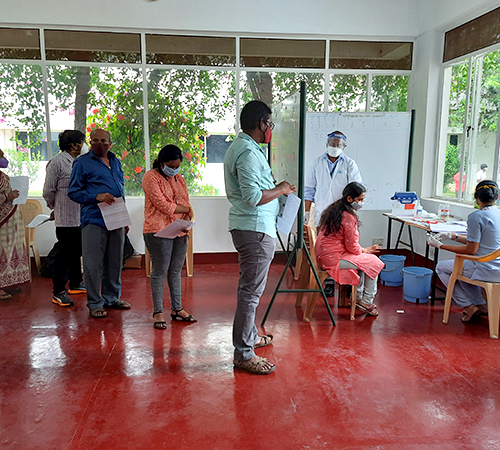 people holding umbrellas on a busy street at night lit by street lights and illuminated signs in Tokyo, Japan