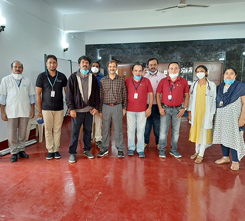 car interior from central back seat position showing driver and blurred view through windscreen of a busy road at night